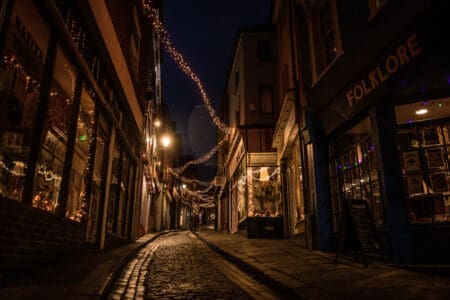 A cobbled street adorned with fairy lights