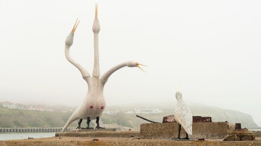 Three headed bird rising from the sea