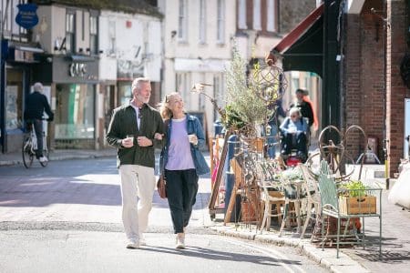 A couple walking down Hythe high Street.