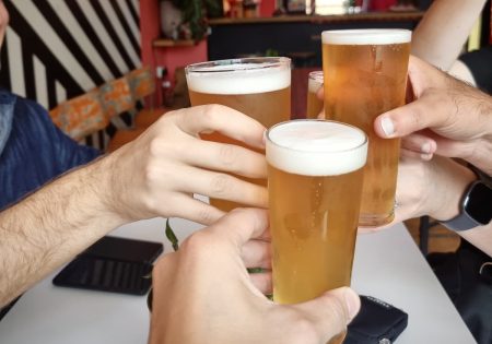 Three glasses of beer being cheers to