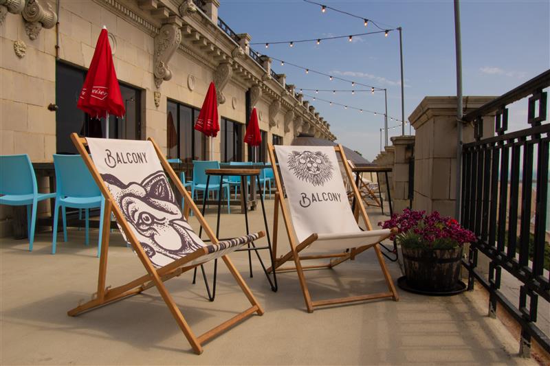 A pair of Balcony Bar deck chairs on a sunny balcony